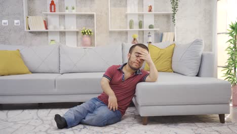 Frustrated-young-man-with-dwarfism-is-thoughtful-depressed-at-home.